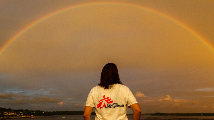 MSF staff in front of a rainbow in the Amazon region.